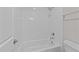 Clean white tiled shower and tub combination with updated fixtures in the bathroom at 7502 Latteri Ct, Raleigh, NC 27613