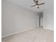 Bright bedroom features neutral carpet, ceiling fan, and white trim with convenient access to other rooms at 7502 Latteri Ct, Raleigh, NC 27613