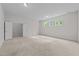 Large, bright bedroom featuring neutral walls, plush carpeting, and natural light at 7502 Latteri Ct, Raleigh, NC 27613