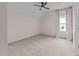 Cozy bedroom features neutral carpet, ceiling fan, and natural light from the window with curtains at 7502 Latteri Ct, Raleigh, NC 27613