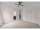 Spacious bedroom offers neutral carpet, ceiling fan, and easy access to the bathroom and walk-in closet at 7502 Latteri Ct, Raleigh, NC 27613