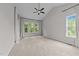 Bright bedroom with a ceiling fan, vaulted ceiling, and natural light from large windows at 7502 Latteri Ct, Raleigh, NC 27613