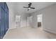 Spacious bedroom features neutral carpet, ceiling fan, and easy access to other rooms at 7502 Latteri Ct, Raleigh, NC 27613