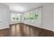 Elegant dining room with chandelier and bright windows offer scenic views of the outdoor space at 7502 Latteri Ct, Raleigh, NC 27613