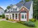 Charming two-story home with a well-manicured lawn, brick accents, and a welcoming front porch at 7502 Latteri Ct, Raleigh, NC 27613