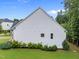 Side exterior view with manicured landscaping and a well-maintained lawn at 7502 Latteri Ct, Raleigh, NC 27613