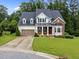 Beautiful two-story home showcasing manicured landscaping, a two-car garage, and a welcoming front lawn at 7502 Latteri Ct, Raleigh, NC 27613