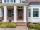 Charming front porch with white columns, brick accents, and an inviting entrance at 7502 Latteri Ct, Raleigh, NC 27613