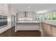 Modern kitchen with large center island, stainless steel appliances, and open layout to dining area at 7502 Latteri Ct, Raleigh, NC 27613