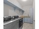 Well-equipped laundry room with modern washer/dryer, storage cabinets, countertop space, and a utility sink at 7502 Latteri Ct, Raleigh, NC 27613