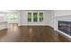 Bright living room with fireplace, built-in shelving, and large windows overlooking the backyard at 7502 Latteri Ct, Raleigh, NC 27613