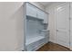 Functional mudroom features custom storage bench, hooks, cabinets, and drawers providing convenient organization at 7502 Latteri Ct, Raleigh, NC 27613