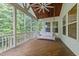 Inviting screened porch with a ceiling fan and comfortable swing sofa at 7502 Latteri Ct, Raleigh, NC 27613