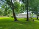 Backyard with white deck and sunroom, view from the other side of lawn at 78 Phil Johnson Rd, Sanford, NC 27330