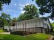 Back of home with a large deck, garden plots, and landscaping at 78 Phil Johnson Rd, Sanford, NC 27330