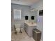Bathroom featuring a sink and cabinet with a decorative sign hanging above the toilet at 78 Phil Johnson Rd, Sanford, NC 27330