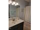 Bathroom featuring a dark vanity, neutral countertops, and a shower with a patterned curtain at 78 Phil Johnson Rd, Sanford, NC 27330