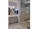 Bright bathroom with hexagon tile floor, a white vanity, and a glass enclosed shower at 78 Phil Johnson Rd, Sanford, NC 27330