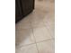 Close up of beige tiled bathroom floor next to dark cabinets at 78 Phil Johnson Rd, Sanford, NC 27330