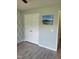 Bedroom featuring a closet, beach-themed picture, and modern gray flooring at 78 Phil Johnson Rd, Sanford, NC 27330