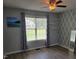 Light-filled bedroom with geometric accent wall, ceiling fan, and modern flooring at 78 Phil Johnson Rd, Sanford, NC 27330
