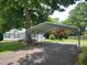 View of a metal carport beside the home and a spacious gravel parking area at 78 Phil Johnson Rd, Sanford, NC 27330