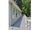 Long and gray painted outdoor deck with white railings off the back of the home at 78 Phil Johnson Rd, Sanford, NC 27330