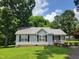 Charming single-story home with a metal roof, black shutters and a welcoming front porch at 78 Phil Johnson Rd, Sanford, NC 27330