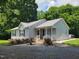 Charming single-story home with a metal roof, landscaped yard, and welcoming front porch at 78 Phil Johnson Rd, Sanford, NC 27330