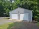 Two-car garage with light gray siding and white doors provides ample parking at 78 Phil Johnson Rd, Sanford, NC 27330