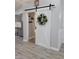 Hallway featuring a white barn door with a wreath at 78 Phil Johnson Rd, Sanford, NC 27330