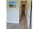 Hallway featuring gray flooring, a beach picture, and white trim at 78 Phil Johnson Rd, Sanford, NC 27330