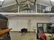 Spacious interior of metal outbuilding featuring ceiling fan, ladder and loft at 78 Phil Johnson Rd, Sanford, NC 27330