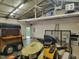 Spacious interior of metal outbuilding featuring ceiling fan and lawn mower at 78 Phil Johnson Rd, Sanford, NC 27330