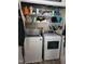 A laundry room with a washer and dryer, and shelves full of cleaning supplies at 78 Phil Johnson Rd, Sanford, NC 27330