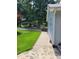 Green lawn and sidewalk lead to the side of the home, with a view of the carport in back at 78 Phil Johnson Rd, Sanford, NC 27330