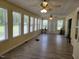 Sunroom with lots of windows, ceiling fans, and hardwood floors at 78 Phil Johnson Rd, Sanford, NC 27330
