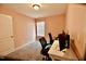 Home office with plush carpet, a white desk and an adjustable window blind at 83 Mariners Point Way, Garner, NC 27529