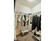 Walk-in closet featuring ample storage space, shelving, and hanging racks for organization at 83 Mariners Point Way, Garner, NC 27529