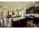 Kitchen featuring dark cabinetry, a center island, hardwood floors and stainless steel appliances at 83 Mariners Point Way, Garner, NC 27529