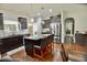 Kitchen featuring dark cabinetry, a center island with seating and stainless steel appliances at 83 Mariners Point Way, Garner, NC 27529
