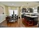 Kitchen featuring dark cabinetry, a center island with seating and stainless steel appliances at 83 Mariners Point Way, Garner, NC 27529