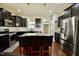 Kitchen featuring dark cabinetry, a center island with seating, and stainless steel appliances at 83 Mariners Point Way, Garner, NC 27529