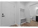 Bright foyer with a white front door, built-in bench, and easy access to a half-bathroom at 834-836 Day Ave, Burlington, NC 27217