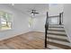 Bright living room features hardwood floors, a ceiling fan, and staircase to the upper level at 834-836 Day Ave, Burlington, NC 27217