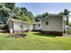 Exterior shot of the house with a large backyard, mature trees, and a propane tank at 835 Pearleman Teague Rd, Siler City, NC 27344