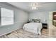 Cozy bedroom featuring a queen size bed, ceiling fan, and an adjacent bathroom at 835 Pearleman Teague Rd, Siler City, NC 27344