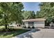 Well-maintained house featuring lush trees, a driveway, and tasteful landscaping at 835 Pearleman Teague Rd, Siler City, NC 27344