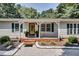 Inviting porch with covered entryway and a decorative wooden door surrounded by lush shrubbery at 835 Pearleman Teague Rd, Siler City, NC 27344