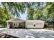 Exterior view of the house with a garage and back porch nestled amongst leafy green trees at 835 Pearleman Teague Rd, Siler City, NC 27344